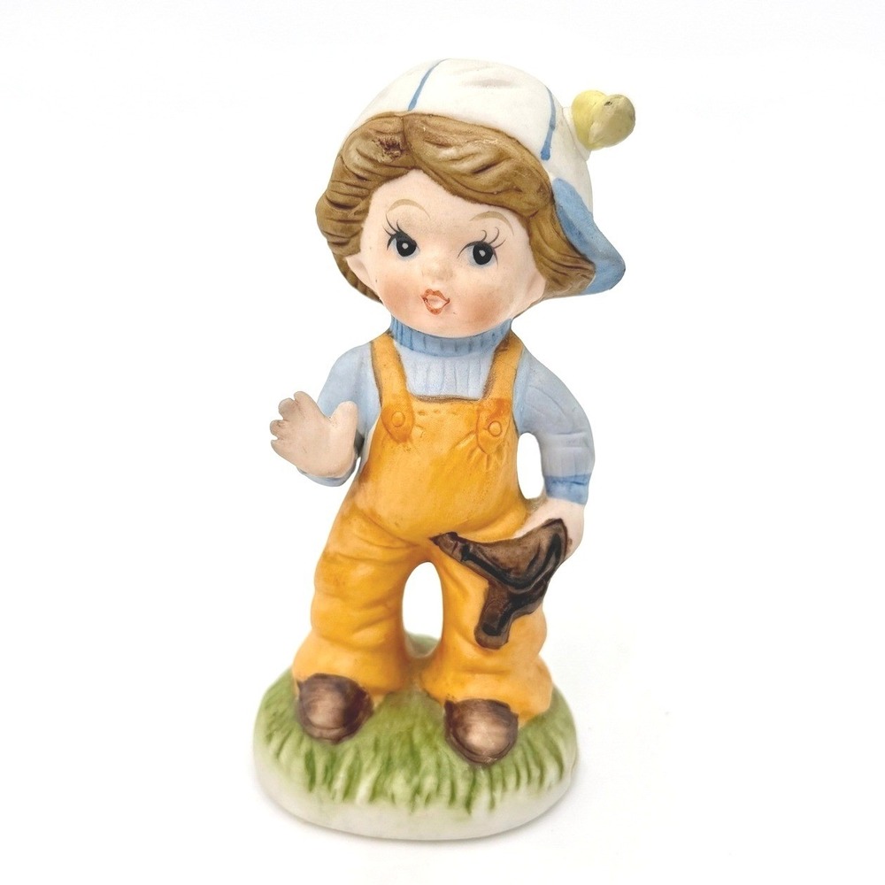 Vintage Bisque Porcelain Boy Figurine Slingshot Bird Hat Orange Overalls - Picture 1 of 6